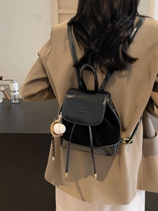 Fashionable black mini leather backpack for women with baseball glove charm accessory