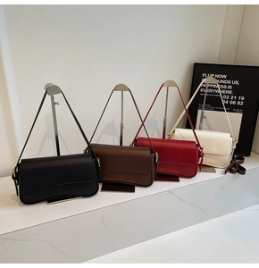 Detail of four premium lychee grain leather underarm bags in black, coffee, red and cream
