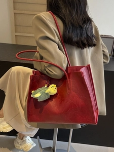 Chic red oversized leather tote bag for women featuring a cute turtle charm accessory