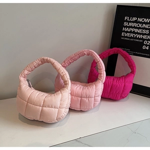 Quilted puffy cloud handbags in three pink shades on minimalist marble background