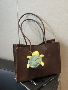 Retro dark coffee large leather tote bag with a cute turtle plush keychain accessory
