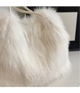 Gros plan sur la texture douce en fausse fourrure d'un sac seau en peluche blanc crème