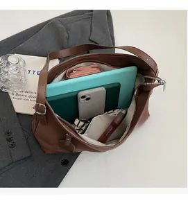 Interior view showing the large capacity of the brown leather tote for iPad and essentials