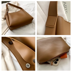 Detailed views of brown PU leather tote bag stitching, magnetic buckle and zipper pocket