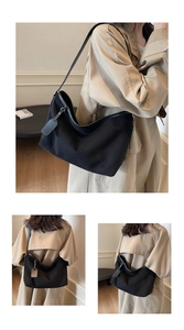 Macro detail of a black large capacity nylon shoulder bag with a sleek minimalist design