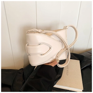 Detail showing the layered weaving hollow structure on the creamy white leather bucket bag