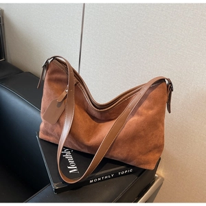 Vintage brown suede hobo bag with adjustable strap and spacious interior for women