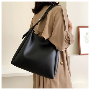 Detail of adjustable strap on a minimalist black leather hobo bag for women
