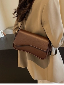 Classic dark brown pebble leather underarm bag with a vintage minimalist shoulder design