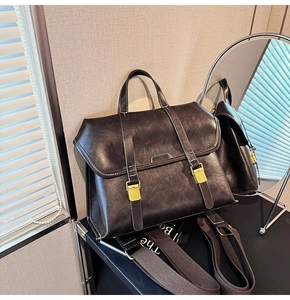 Macro detail of dark brown retro leather satchel with golden buckle and textured finish