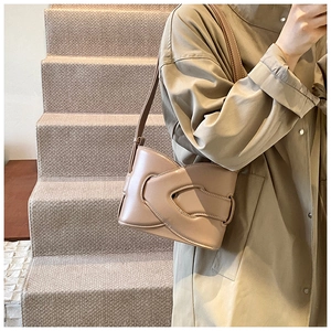 Detail of khaki leather bucket bag featuring unique woven geometric overlapping design