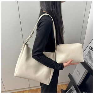 Detail view of cream white bucket bag set including a large tote and matching zipper pouch