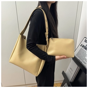Close-up of beige tote bag set with adjustable shoulder strap and matching pouch