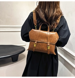 Retro caramel brown leather backpack shown on a model in a minimalist studio setting