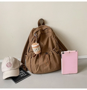 Brown nylon backpack with drawstring closure and side pockets for casual daily commute