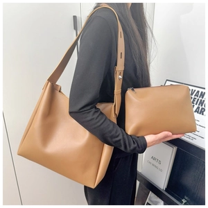 Detail view of the brown leather bucket bag set with its matching interior zipper pouch