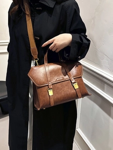 Classic brown vintage messenger bag with matte leather texture and wide fabric strap