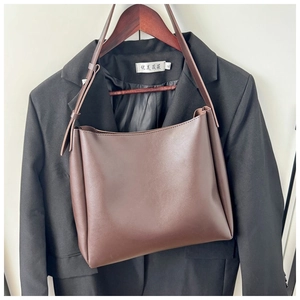 Detailed view of dark coffee minimalist shoulder bag with matte finish and adjustable strap