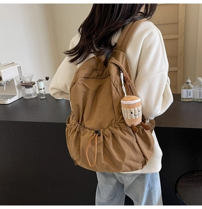 Brown lightweight nylon drawstring backpack with a cute coffee plush pendant detail