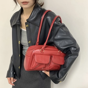 Chic bright red leather underarm tote bag with front flap pockets and gold hardware