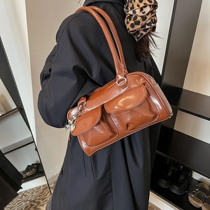 Brown glossy faux leather underarm bag with double front pockets and heart charm