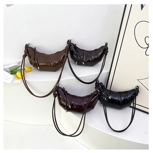 Close-up of crescent hobo bags in four retro colors with pleated patent leather textures