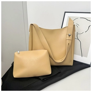 Detail view of the beige minimalist leather bucket bag and matching inner pouch