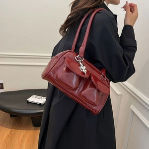 Retro dark red patent leather shoulder bag with glossy finish and silver heart charms