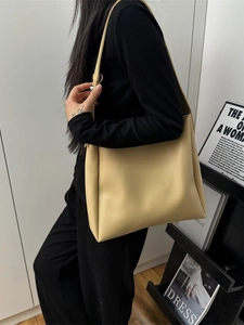 Minimalist beige matte leather tote bag with long shoulder straps for daily commuting