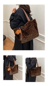 Close-up of leopard print faux fur tote bag with brown leather straps and puppy charm