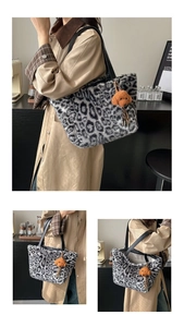 Detail view of large leopard print plush tote bag with a brown teddy dog charm