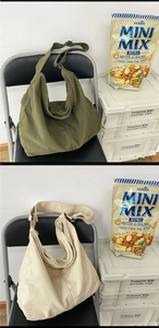 Army green and beige canvas hobo bags with adjustable wide straps and zip closure