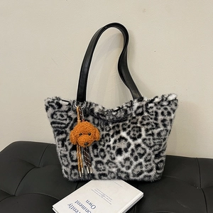 Faux fur leopard print tote bag with black handles and cute orange puppy charm