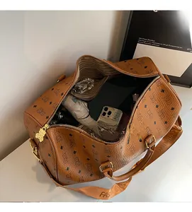Top view of large brown duffle bag with adjustable strap showing spacious interior items
