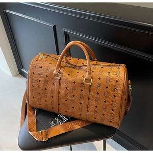 Detail of travel bag with diamond bear pattern, golden hardware and classic wide strap
