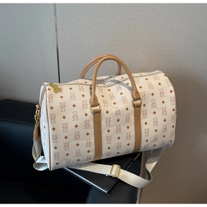 Detail of Boston-style travel bag with bear print and champagne gold hardware accents