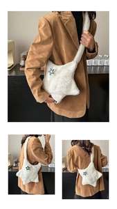 Detail of plush star-shaped crossbody bag featuring soft faux fur texture and matching strap