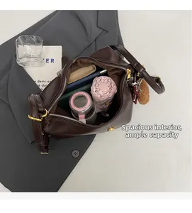Interior view of large capacity dark brown leather tote bag with umbrella and bottle