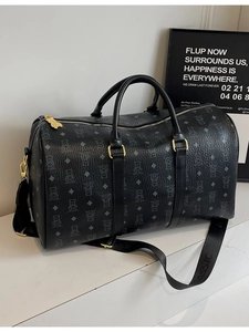 Large black travel duffel bag with bear prints and detachable shoulder strap shown at 45 degrees
