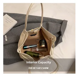 Internal capacity of large cream tote bag with smartphone and cosmetics inside