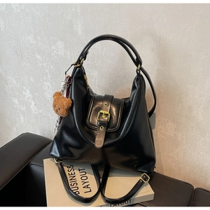 Black glossy leather convertible tote bag with gold buckle and cute bear charm detail