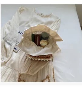 Top view of pearl-embellished straw bucket bag showing interior space for wallet and cosmetics