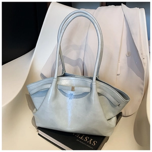 Detail view of light blue pleated tote bag with metal buckle on a white chair