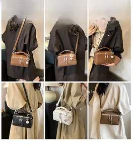 Detailed views of vintage Boston bag showing crossbody wear and litchi texture finish