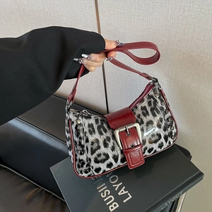 Bolso de leopardo moderno con ribete de cuero rojo oscuro y remaches plateados