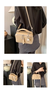 Detailed views of a beige Boston leather handbag with silver hardware and a sphere charm