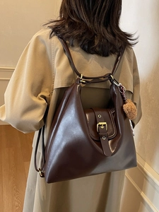 Vintage large capacity brown tote bag worn over the shoulder with a plush ball charm