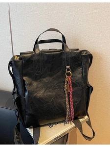 Sac à dos rétro en cuir noir à grande capacité au style vintage sur des livres de business