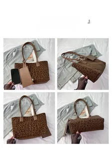 Detail view of large leopard print suede tote bag with matching zippered pouch and leather handles