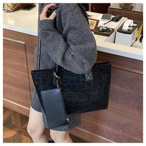Detail of black leopard print suede tote bag with matching zippered pouch on inner strap